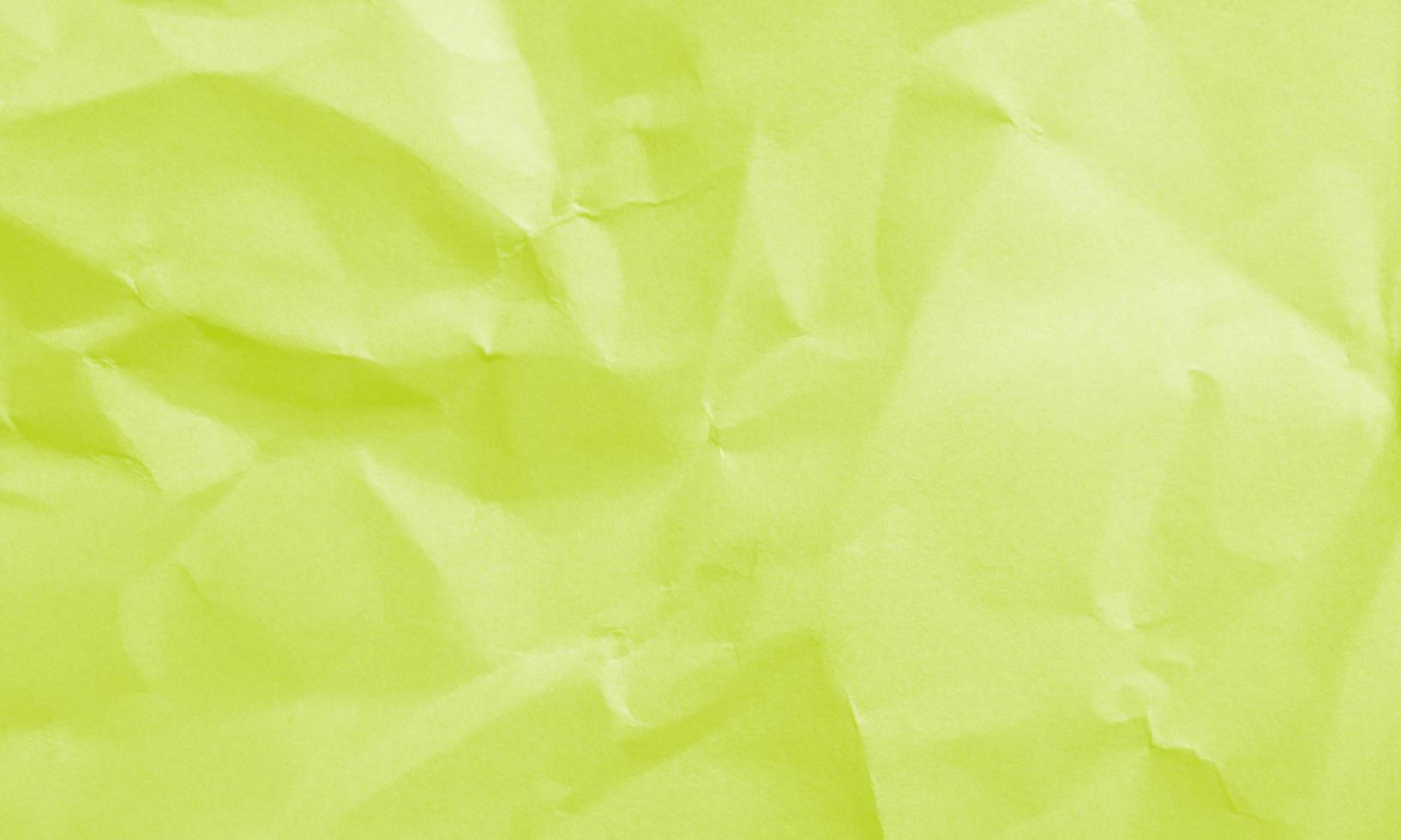 chartreuse colored crumpled paper texture background for design, decorative. photo