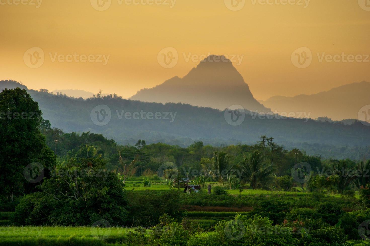 Morning panorama in a small village with a beautiful mountain photo