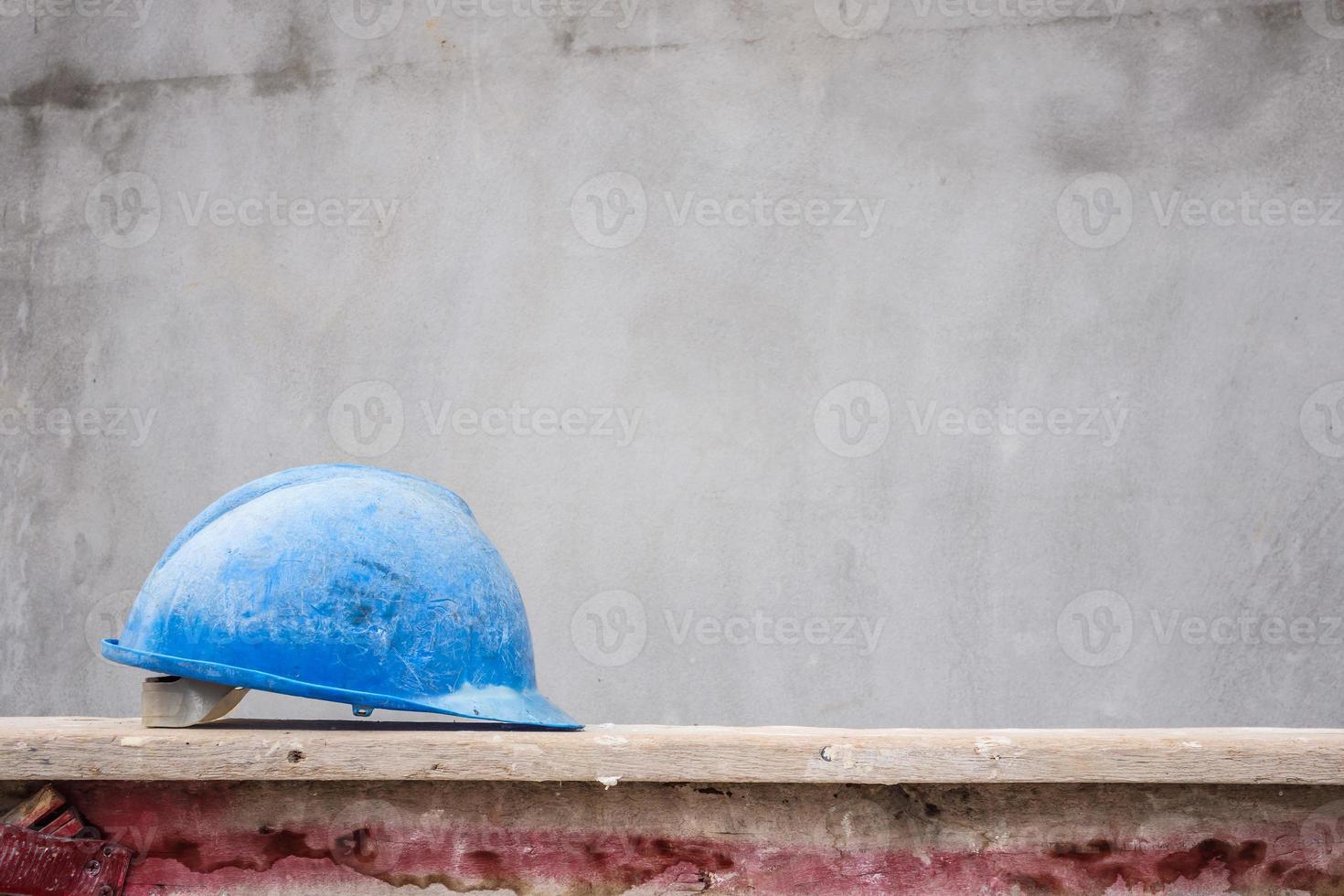 Blue hard hat on house building construction site photo