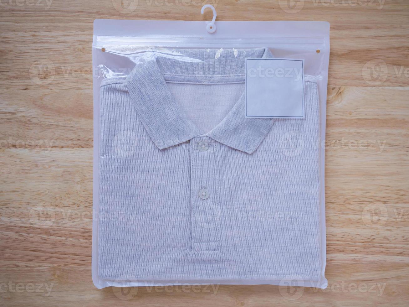 men t-shirts in plastic package on wood photo