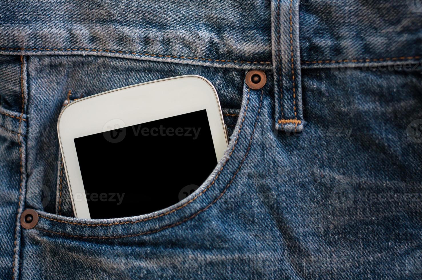 mobile phone in jeans pocket with black screen photo