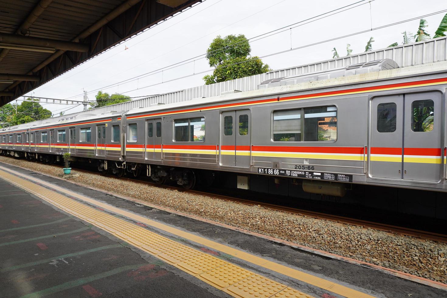 Commuter Line train arrives at a station railway station, Jakarta. photo