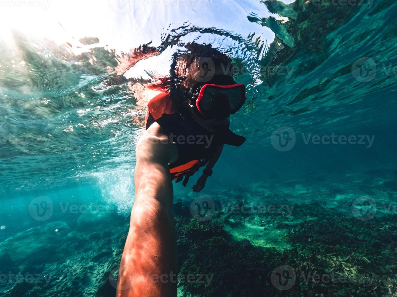 Snorkeling in the sea on a tropical island photo