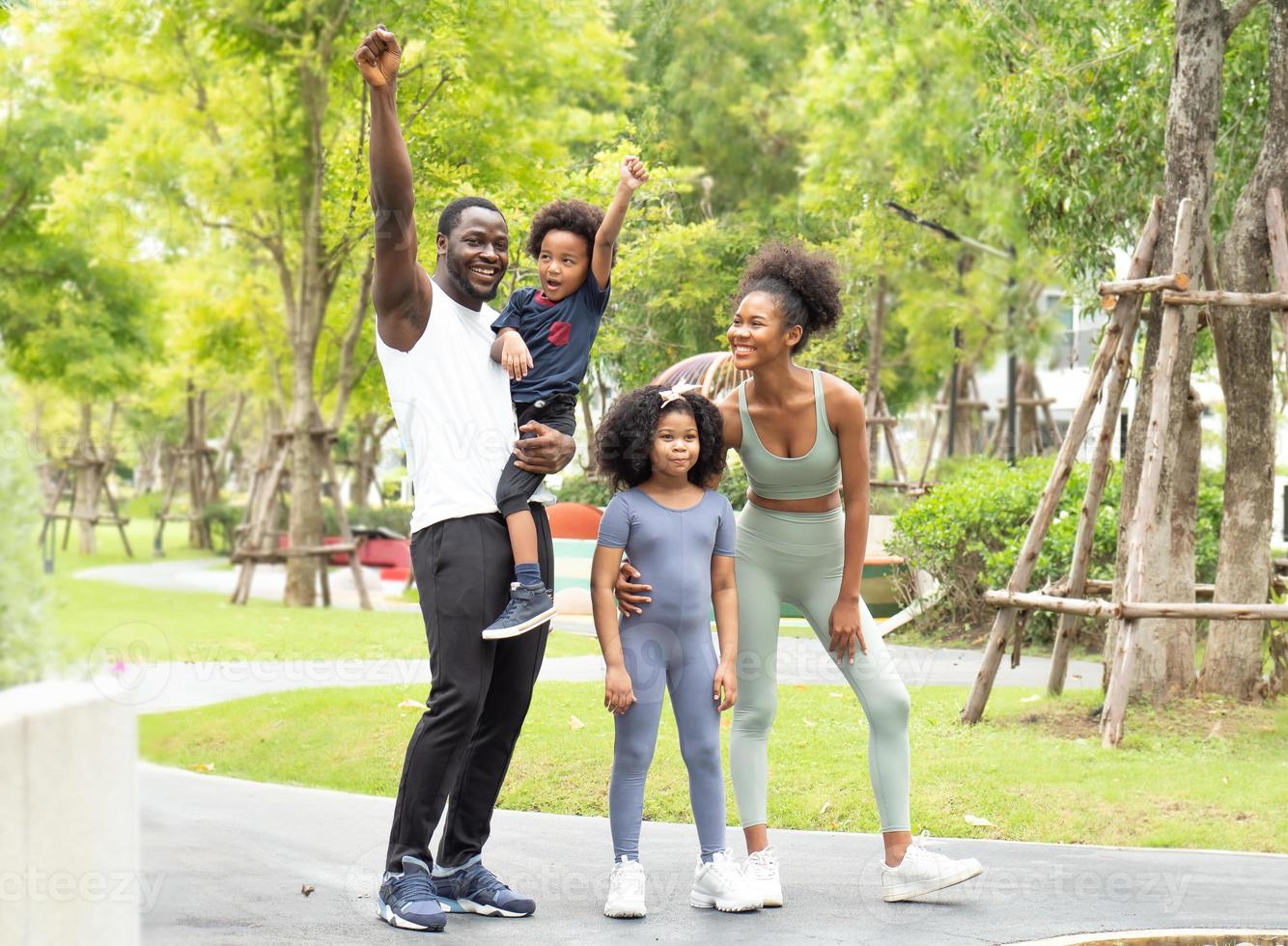 Happy family exercise in natural park. Black skin family, husband and