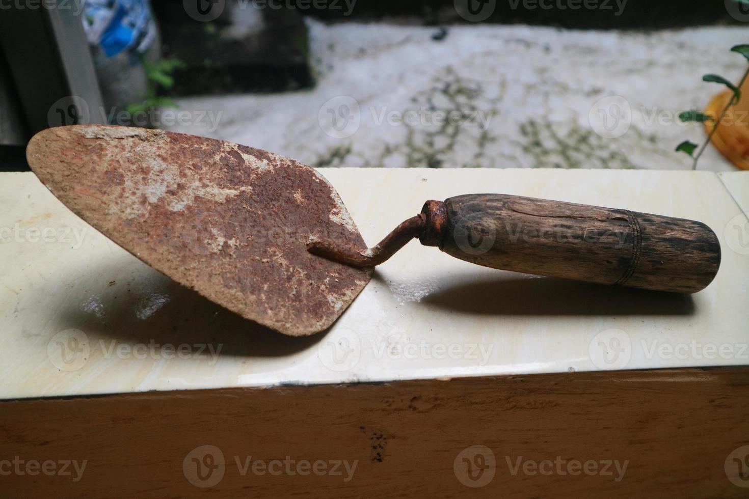 a rusty shovel with a wooden handle photo