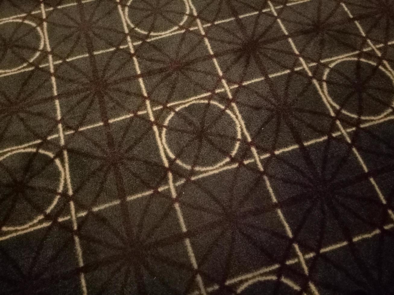 dark brown carpet with circle and square motif in the room photo
