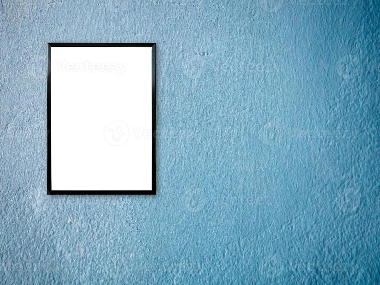 poster frame on blue paint wall background photo