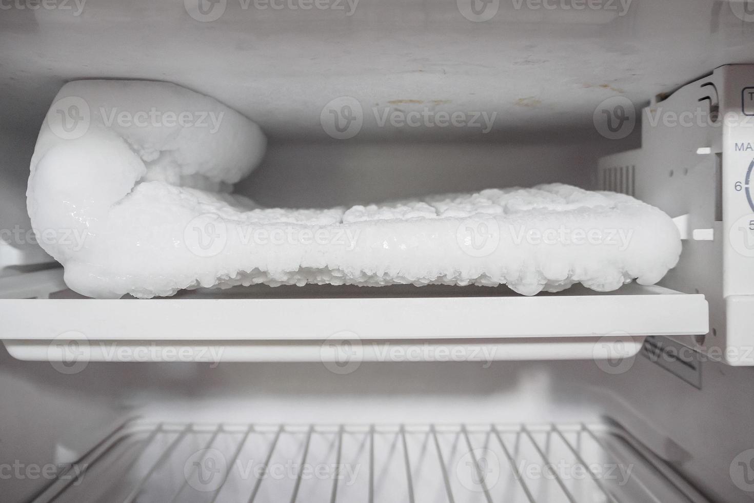 frozen Ice buildup in the freezer of refrigerator photo