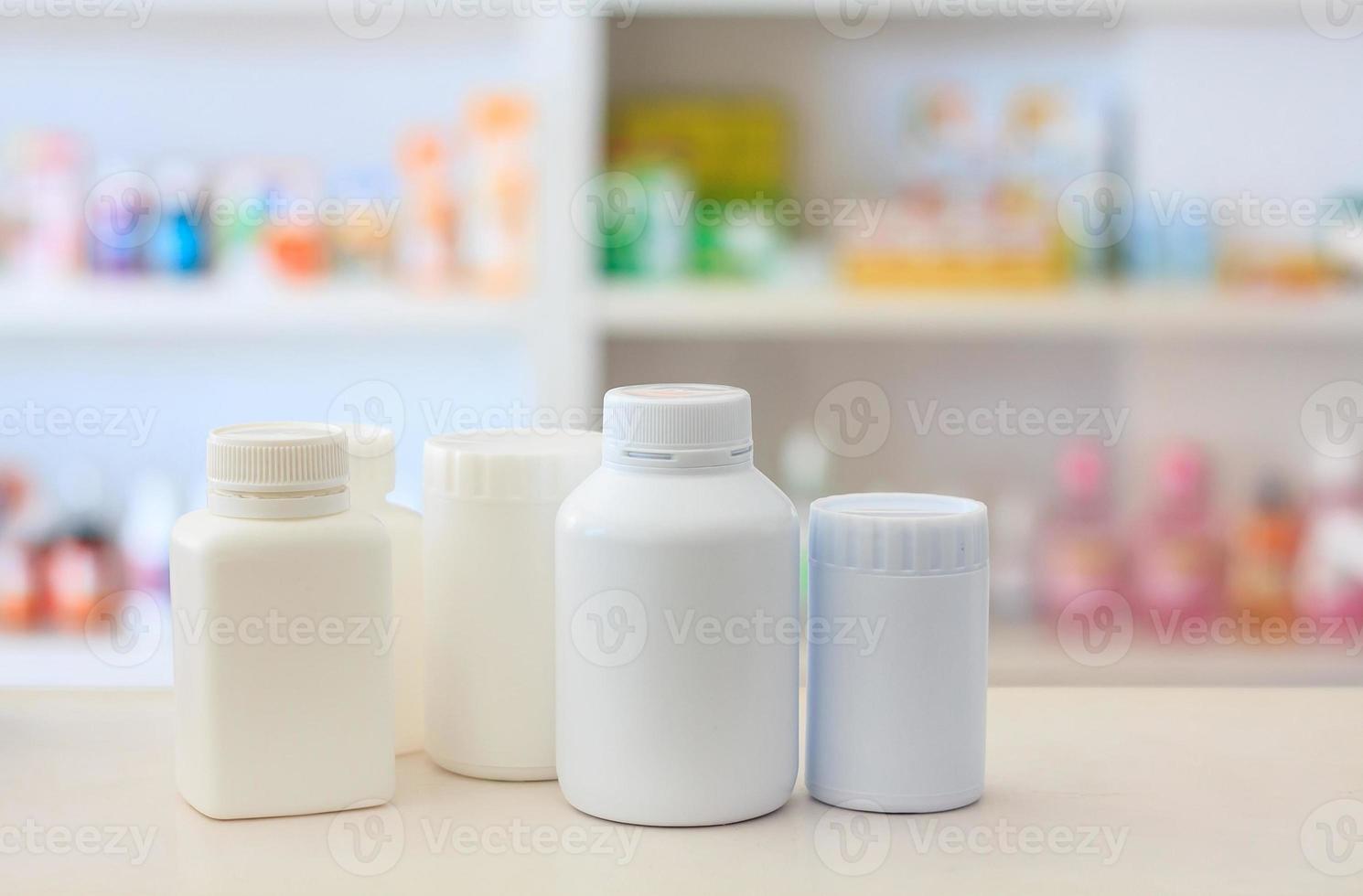 many medicine bottle with blur shelves of drug in the pharmacy drugstore background photo