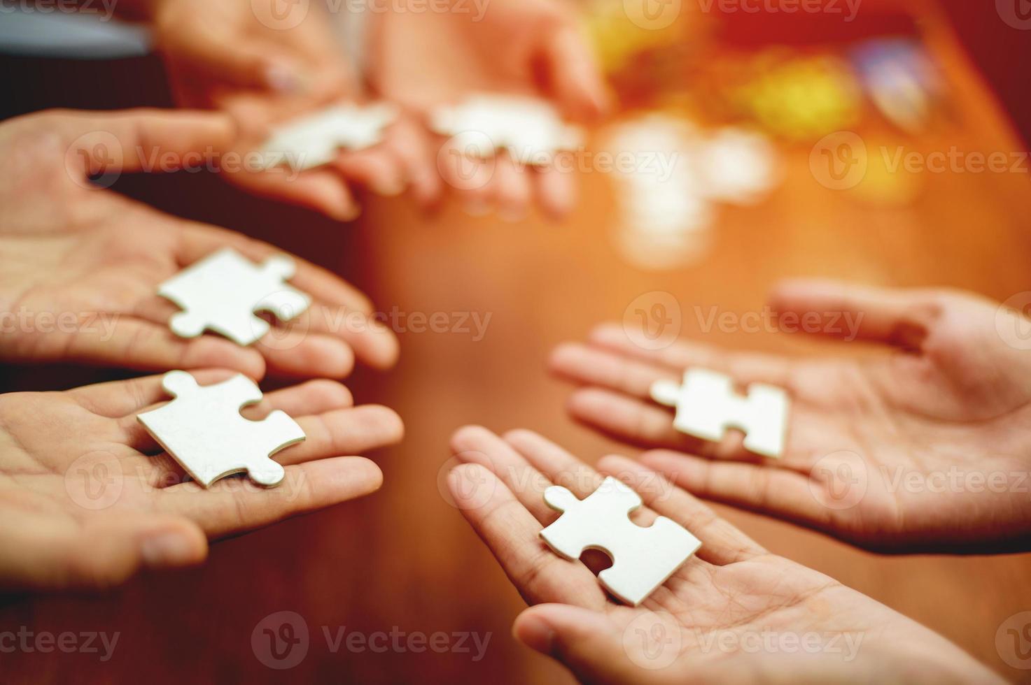 teamwork unity and cooperation concept hand holding jigsaw close-up piece of hand that connect puzzle connected to each other business solution Success Concepts and Strategies photo