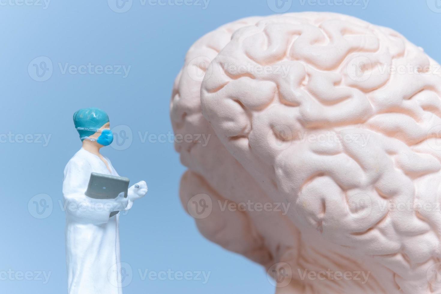 Miniature People Surgeon analyzing patient brain photo