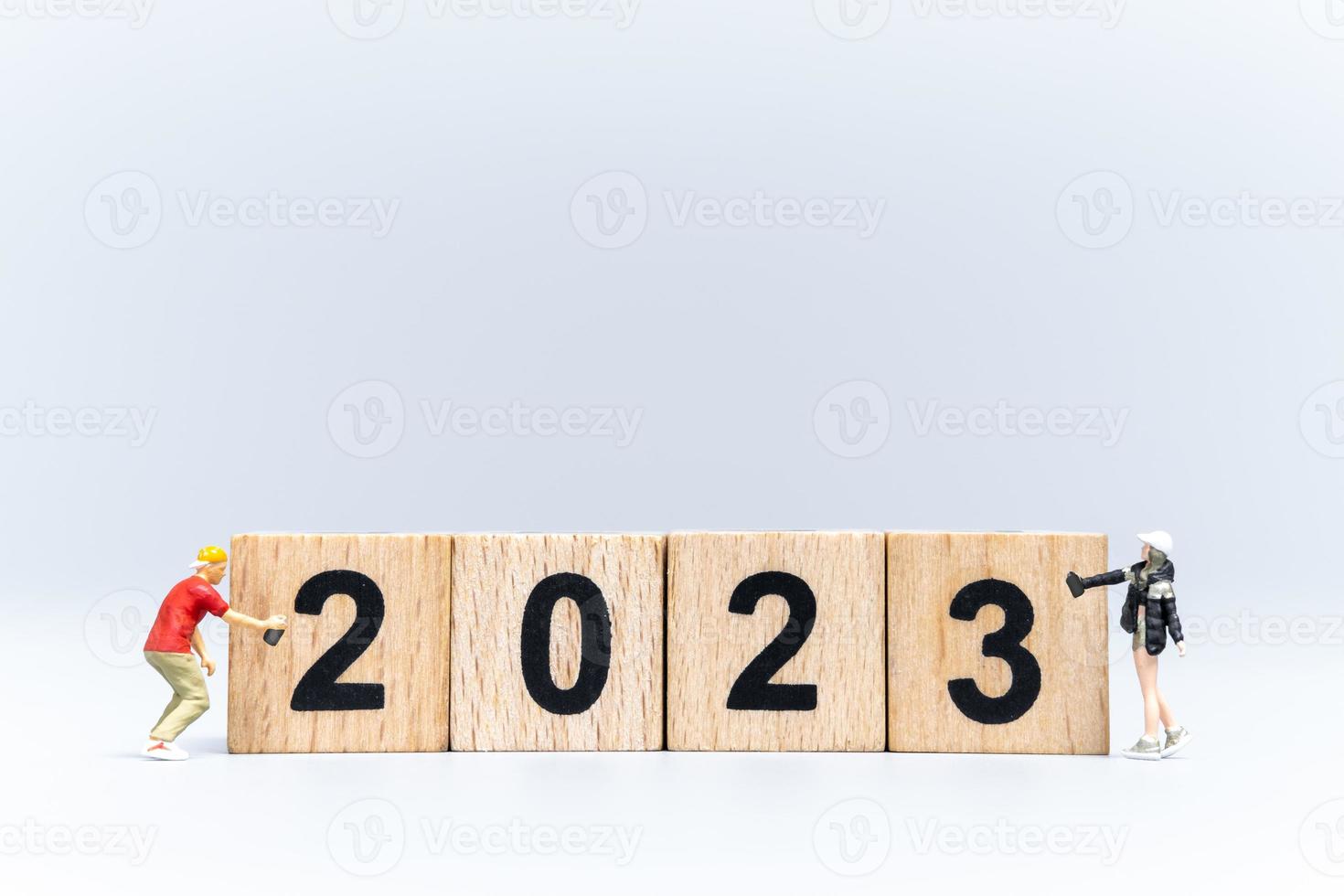 Miniature People Graffiti Artist spraying Number 2023 On Wooden Block photo