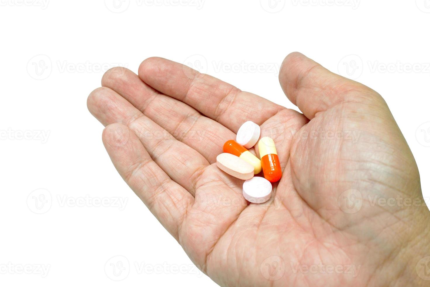 Capsule and medicine tablet on hand isolate on white background and make with paths. photo