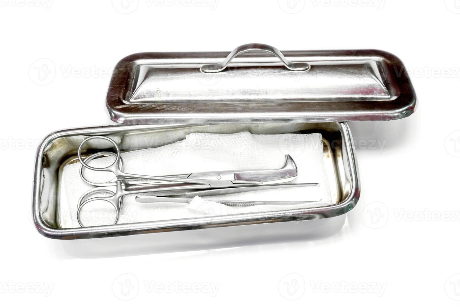 Medical umbilical cord scissor and Medical artery clamp scissor with surgical forceps put on bandage in medical stainless steel container isolate on white background. photo