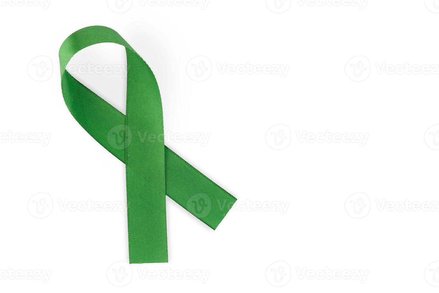 Green ribbon, symbol of social awareness, isolated on white background, top view. World Cancer Day. copy space. photo