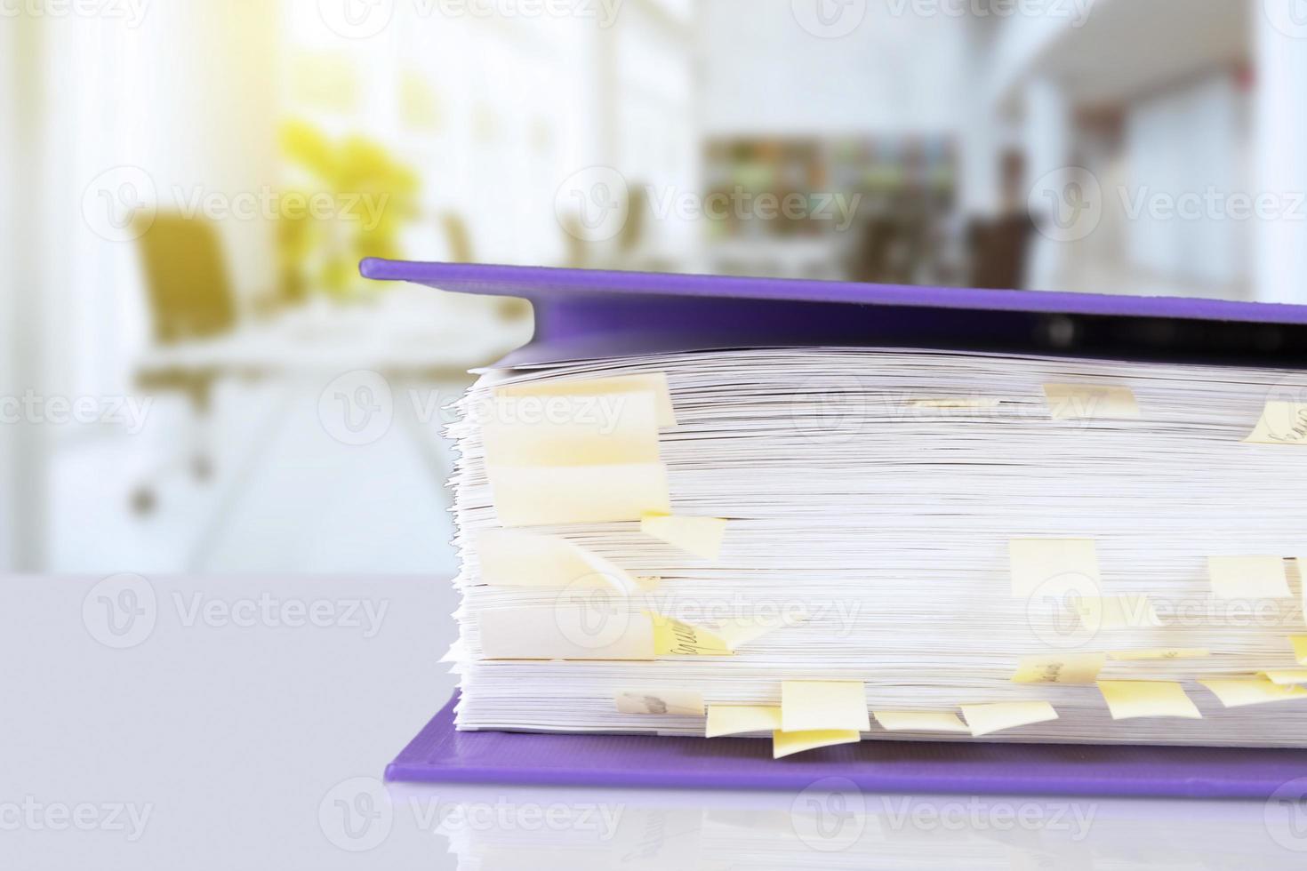 stack of reporting paper documents in a purple folder with bookmarks on the desktop in the office, business documents for annual reports. Business analytics. Business office concept, soft focus. photo