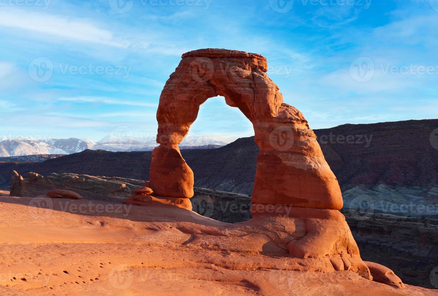 Classic postcard view of famous Delicate Arch, symbol of Utah and a popular scenic tourist attraction, in beautiful golden evening light at sunset in summer, Arches National Park, Moab, Utah, USA photo