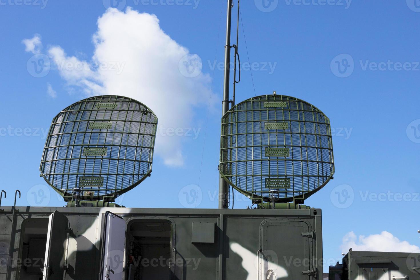 Radiolocating war machine. A target acquisition and distribution radar system. Radar of military machine under open sky. photo