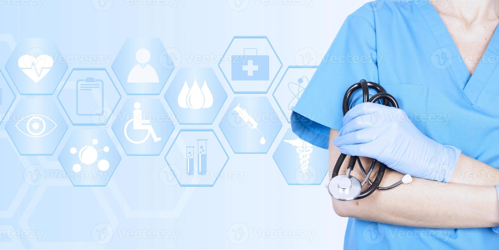 Woman doctor with a stethoscope in medical clothes and gloves, crossed her arms against the background of the concept of medical icons folded in a hexagon. photo