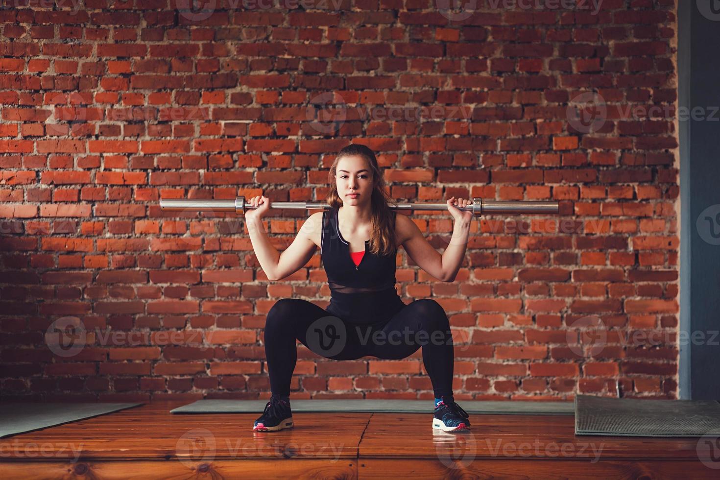 Sportswoman doing an exercise photo
