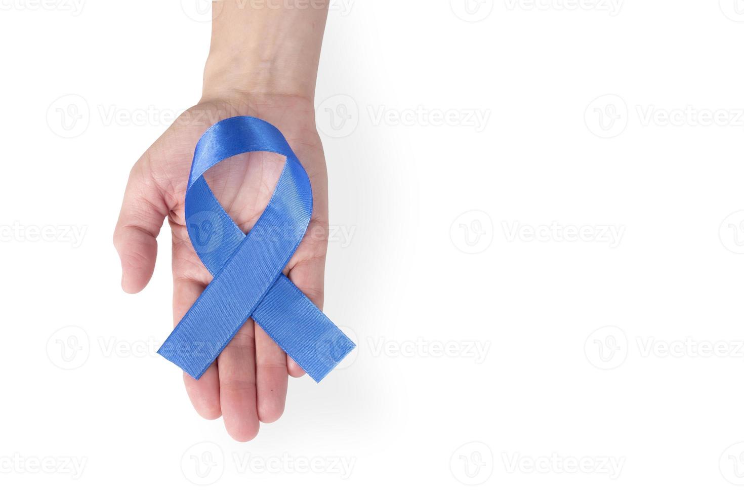 Blue satin ribbon on a woman's palm, isolated on a white background. Cancer awareness symbol, men's health. copy space. photo