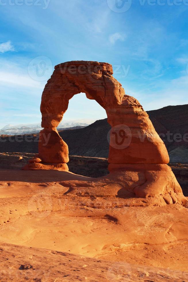 Classic vertical postcard with views of the famous Delicate Arch, Utah symbol and popular tourist attraction, in evening light at sunset in summer, Arches National Park, Moab, Utah, USA photo