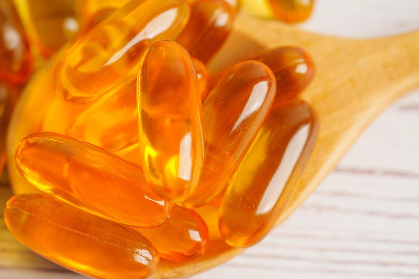 Fish oil or Cod liver oil gel in capsules with omega 3 vitamins, supplementary healthy food photo