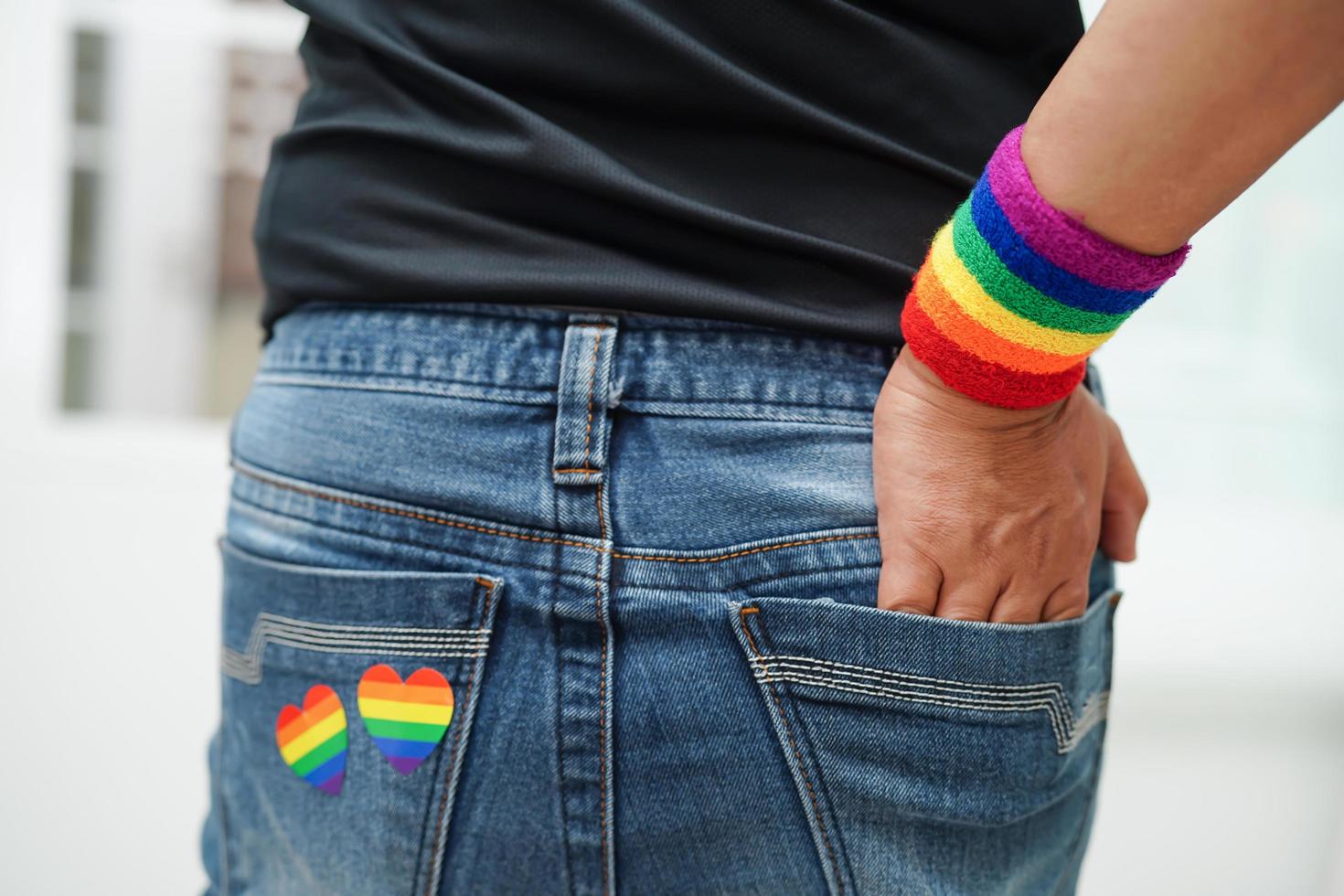 Asian woman with rainbow flag, LGBT symbol rights and gender equality, LGBT Pride Month in June. photo