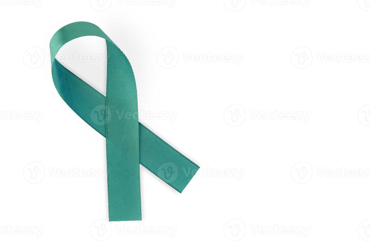 Turquoise ribbon, symbol of social awareness, isolated on white background, top view. World Cancer Day. copy space. photo