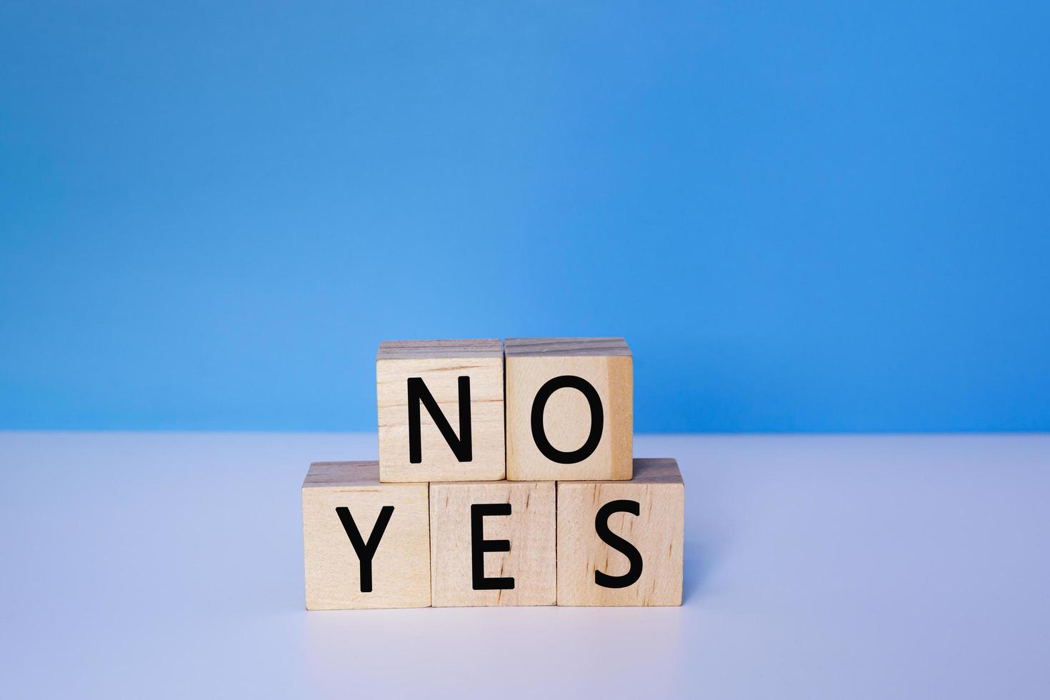 Yes and No on wooden cube. Decision, choosing and answer concept. photo