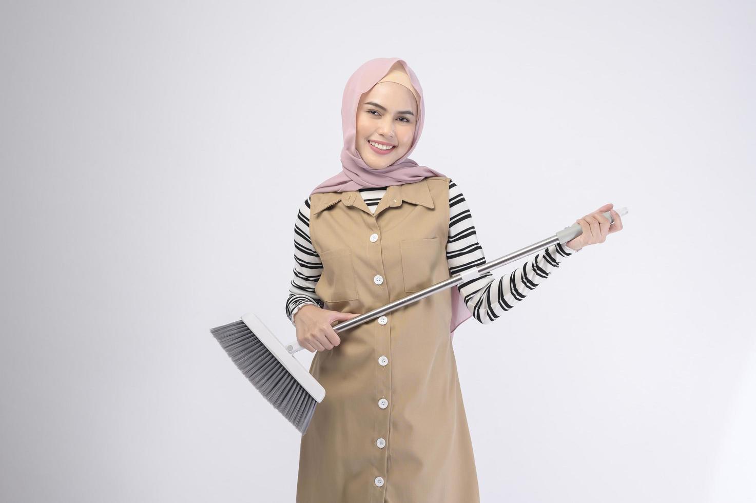 Young muslim beautiful housewife smiling on white background photo