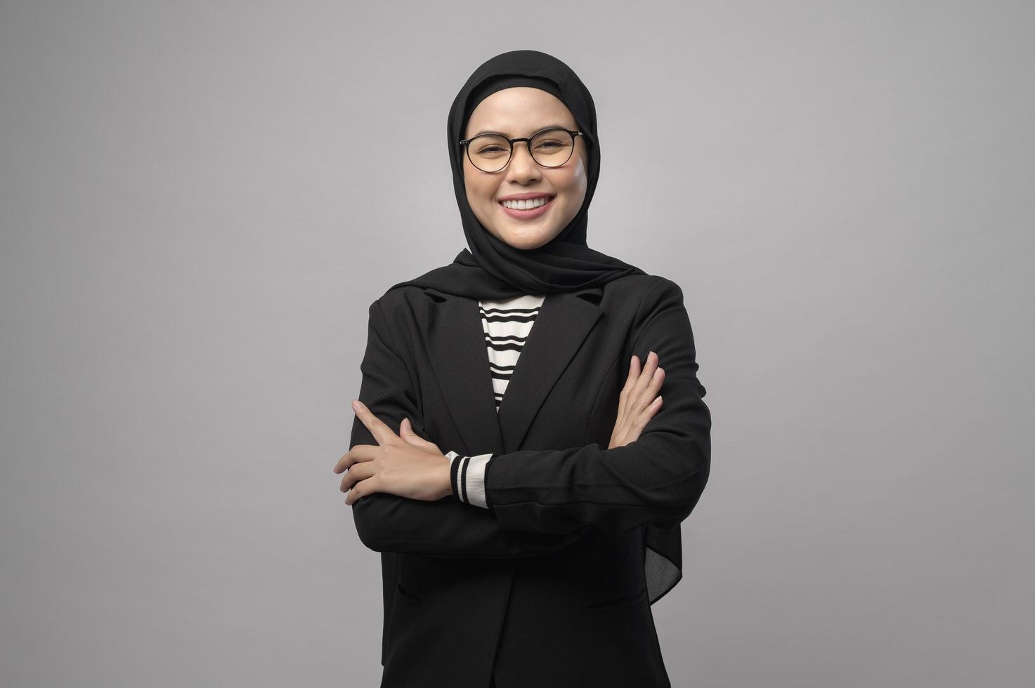 Beautiful muslim woman wearing glasses over white background studio photo