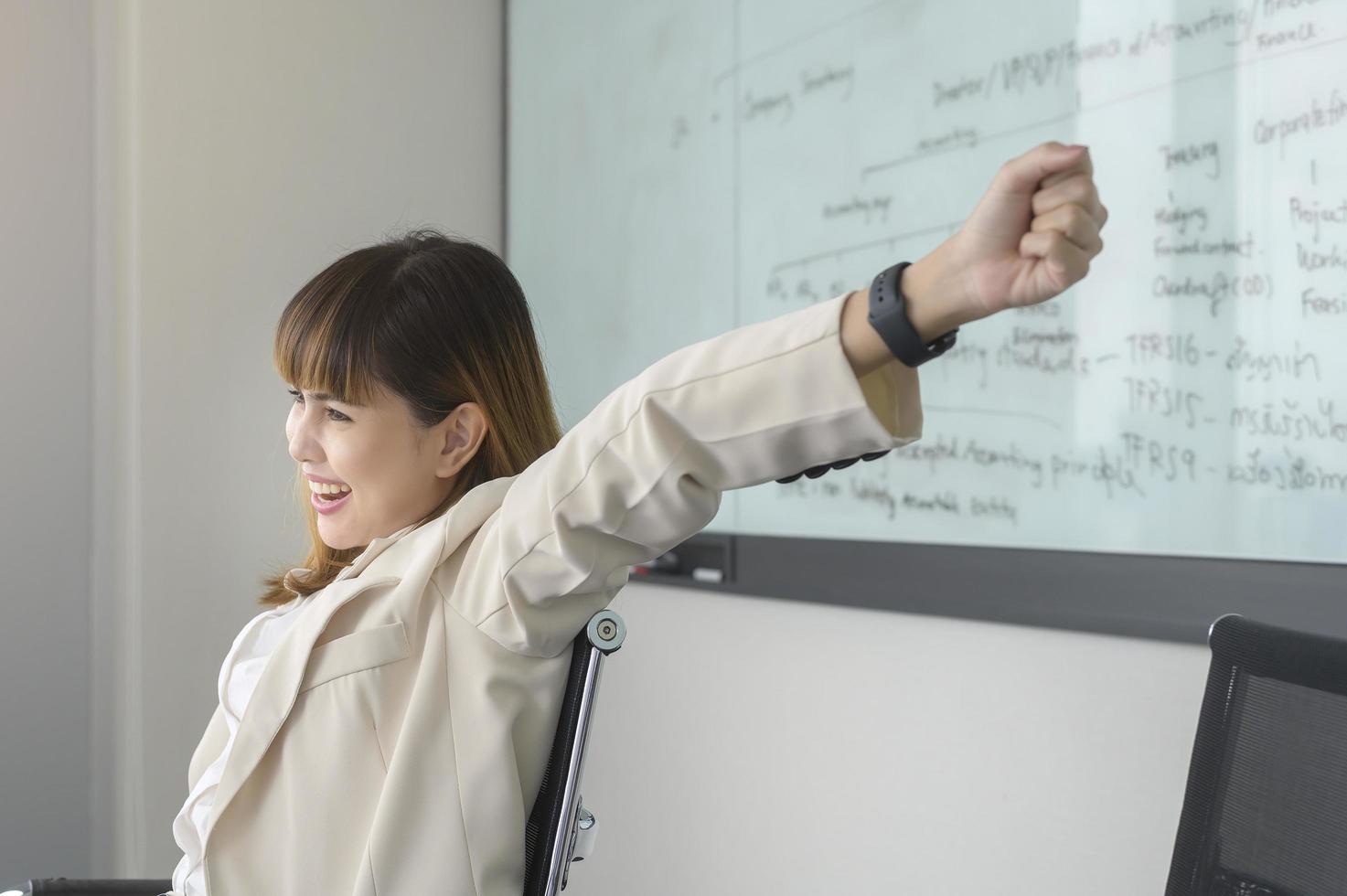 Beautiful business woman  relaxing and stretching in modern office photo