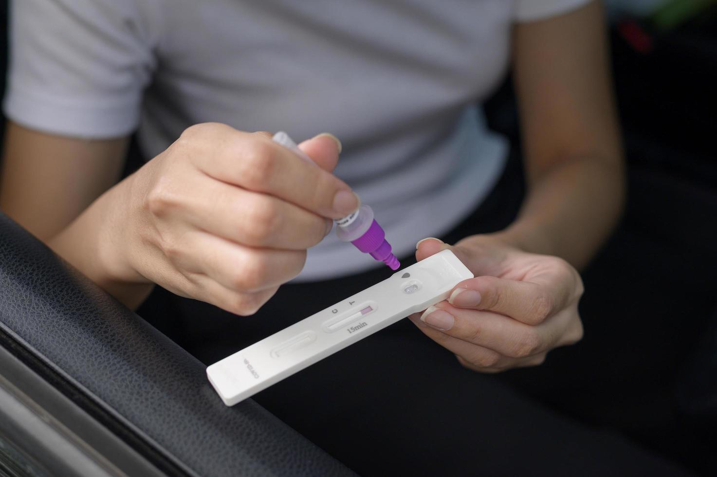 A woman do a self-collection test for a COVID-19 test, health and safety photo