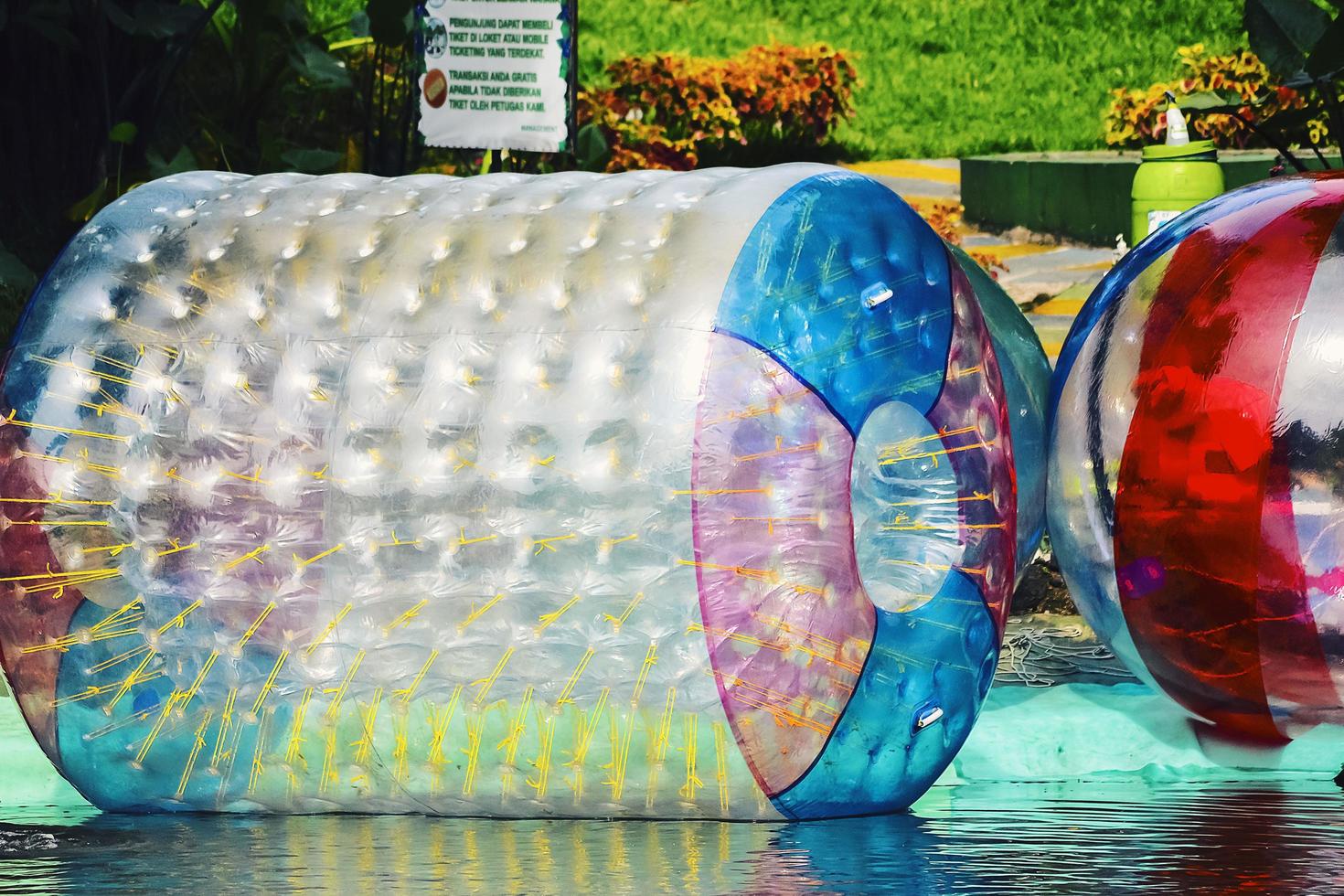 Big balloons that children use to play on the water. Air ball vehicle on water. photo