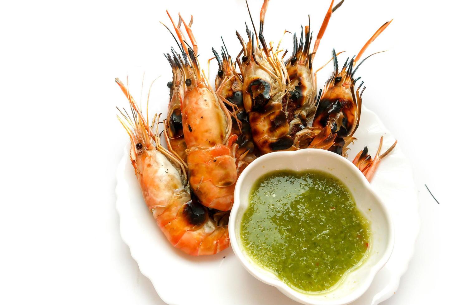 Burned river shrimp, grilled shrimp with spicy green chili seafood sauce isolated on white background photo