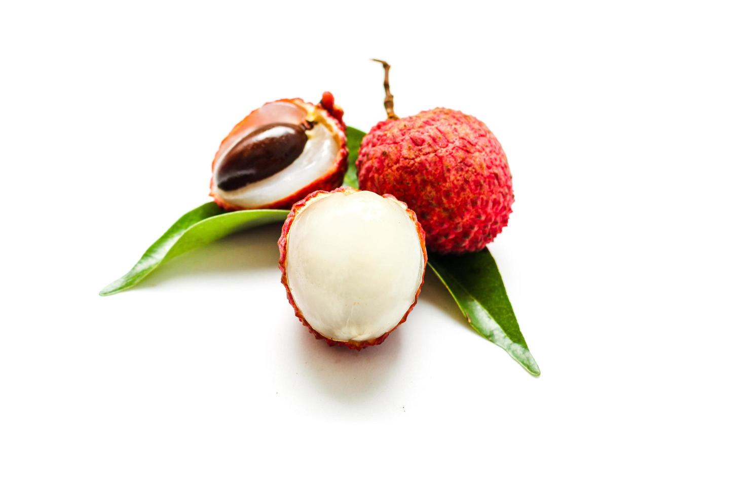 Fresh lychee fruits Litchi with leaves isolated on white background photo