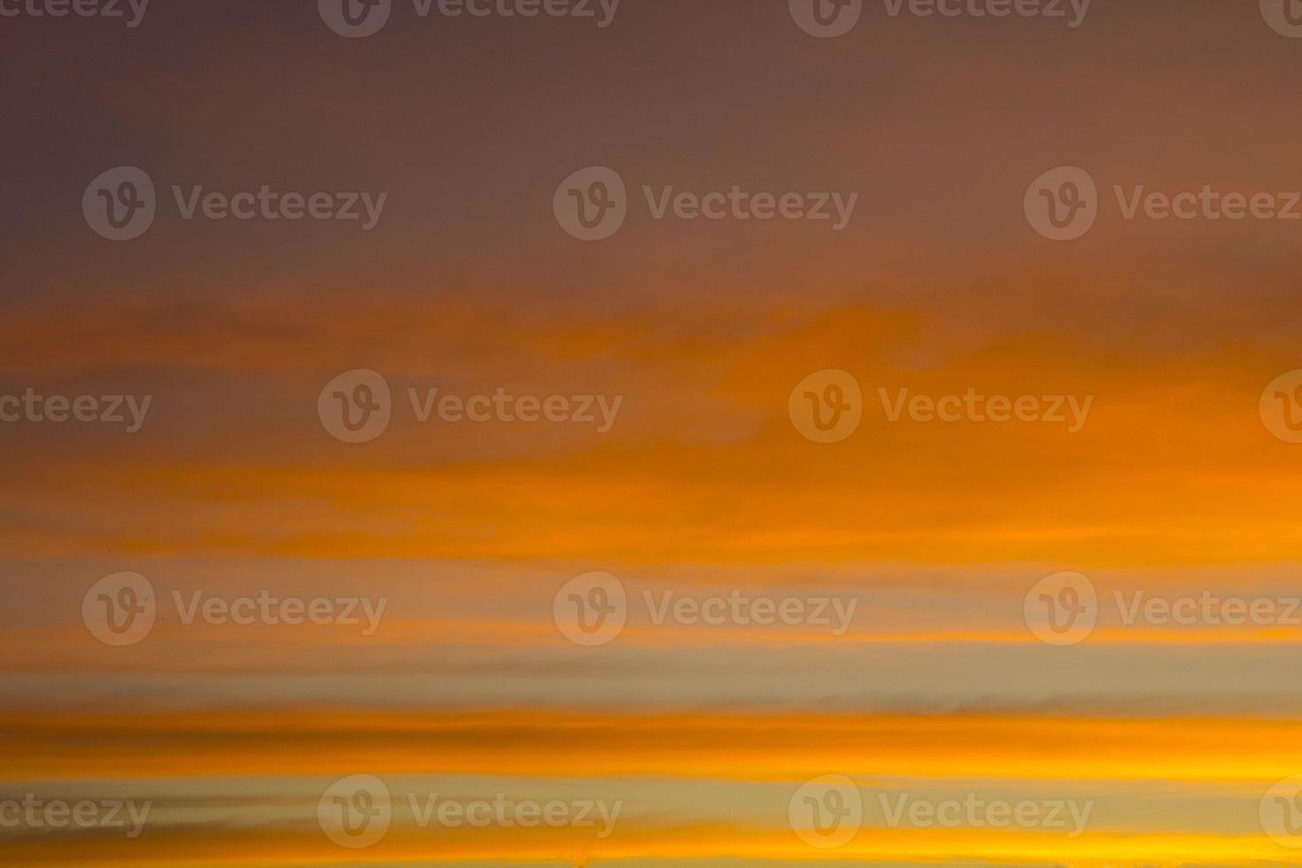 The sky is a horizontal line of yellow-orange and colorful colors in the beautiful evening in the midst of nature which is peaceful, warm and romantic in the countryside and is extremely beautiful. photo