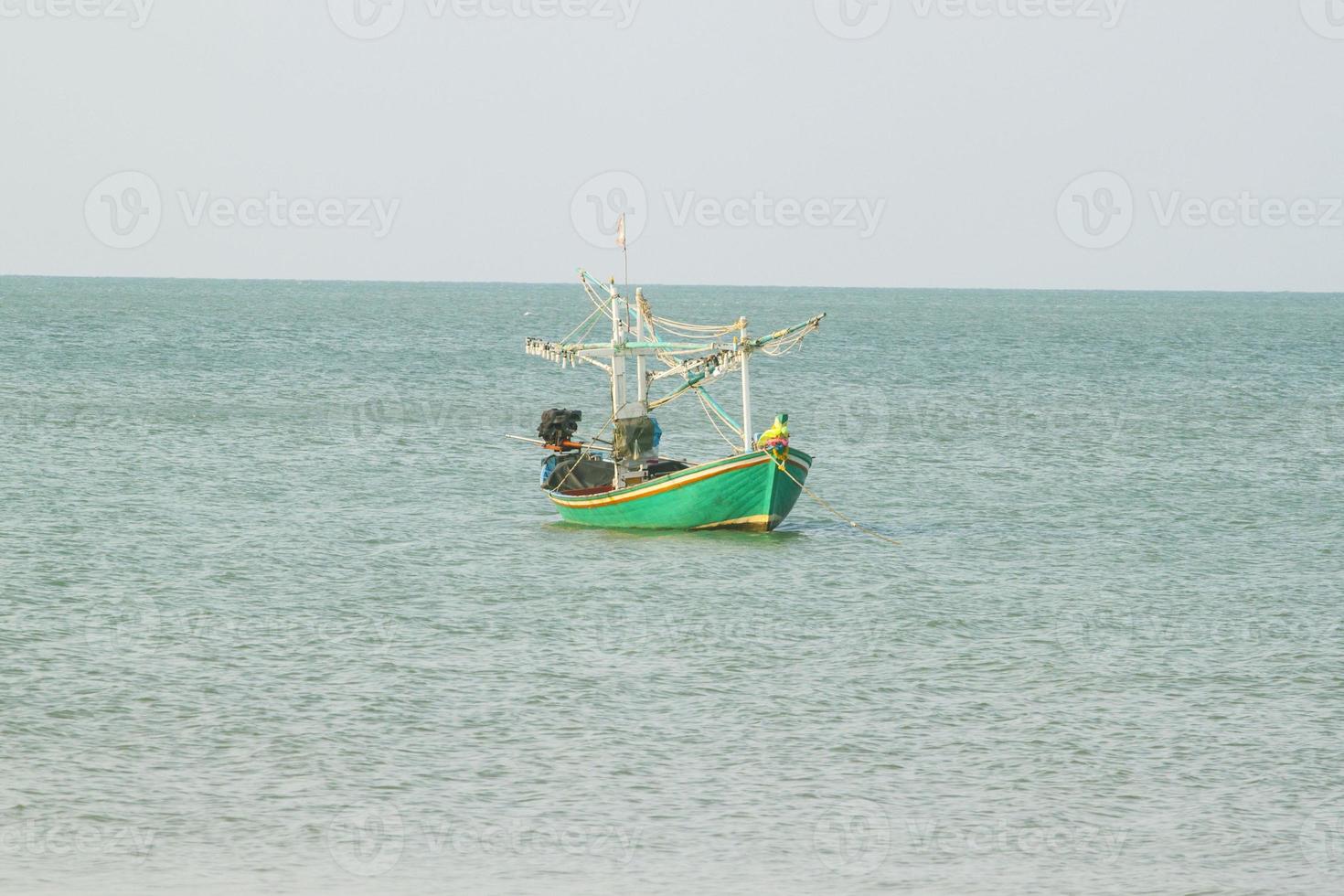 pequeña embarcación pesquera que captura peces y calamares por la costa de forma tradicional y mantiene un ecosistema de peces y vida marina durante mucho tiempo en los días fuertes y ventosos. foto