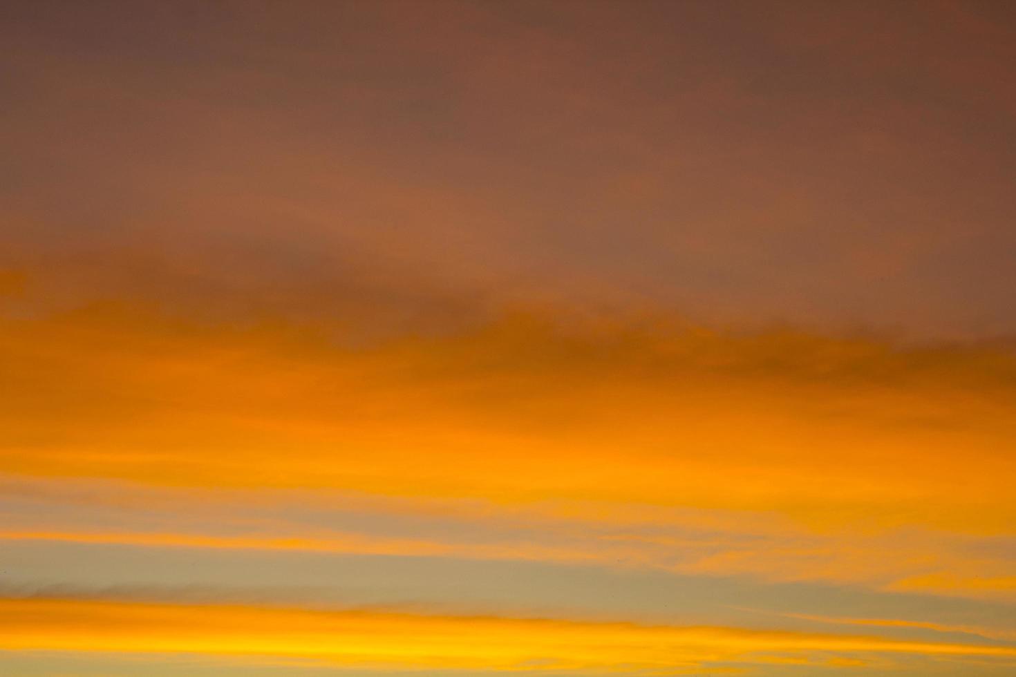 The sky is a horizontal line of yellow-orange and colorful colors in the beautiful evening in the midst of nature which is peaceful, warm and romantic in the countryside and is extremely beautiful. photo