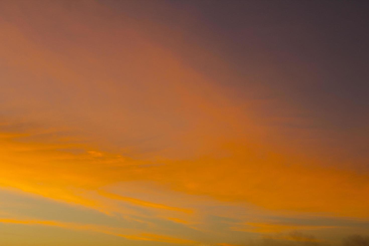 The sky is a horizontal line of yellow-orange and colorful colors in the beautiful evening in the midst of nature which is peaceful, warm and romantic in the countryside and is extremely beautiful. photo