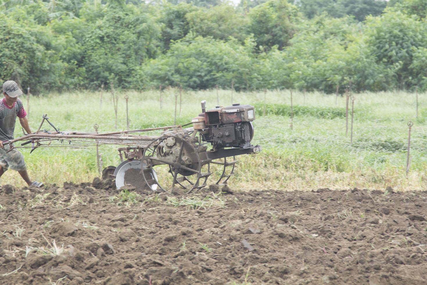 Farmers are preparing the soil for growing local vegetables using walk-behind tractors and the labor of farmers in rural Thailand who use labor and energy to improve the land. photo