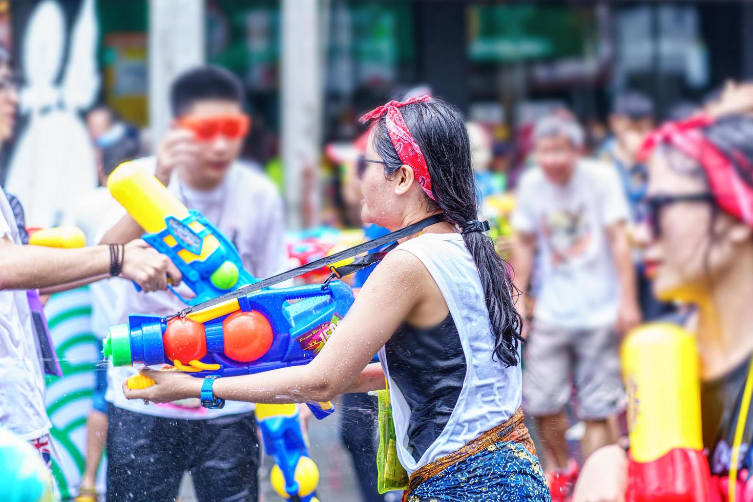 Songkran Festival or Songkran is celebrated in Thailand as the traditional New Year's Day from 13 to 15 April. People getting soaked during Songkran. photo