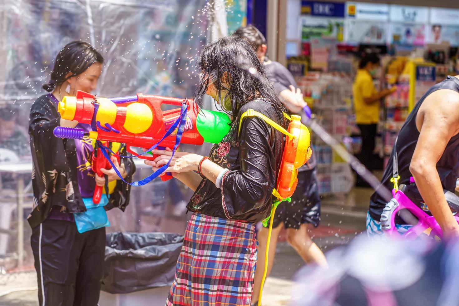 Songkran Festival or Songkran is celebrated in Thailand as the traditional New Year's Day from 13 to 15 April. People getting soaked during Songkran. photo