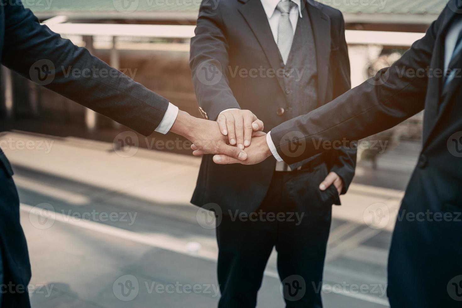 Businessman in suit handshake together for successful in city and walking people background. photo