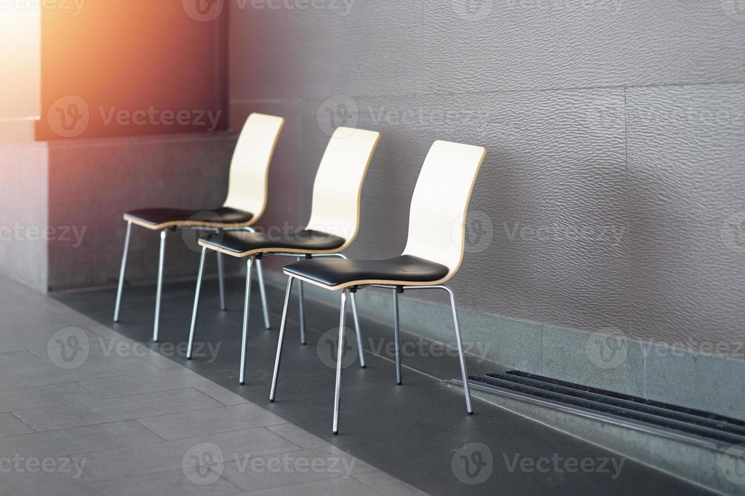 wooden and metal chairs on walkway for resting photo