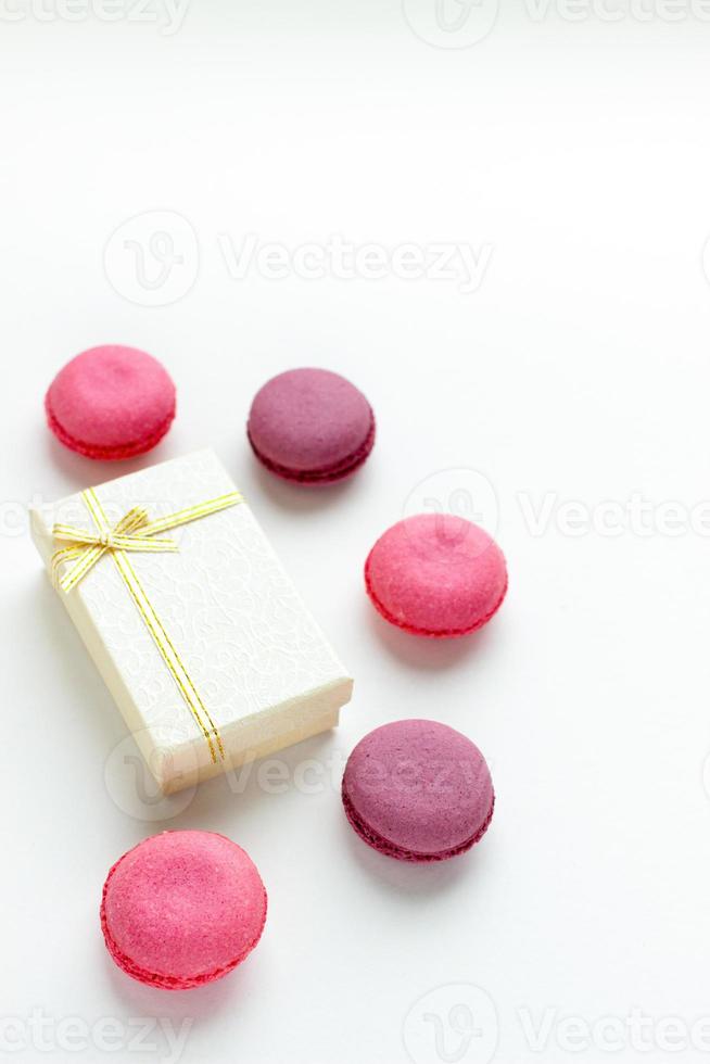 Sweet food minimalist background with cookies and pink macaroons. photo