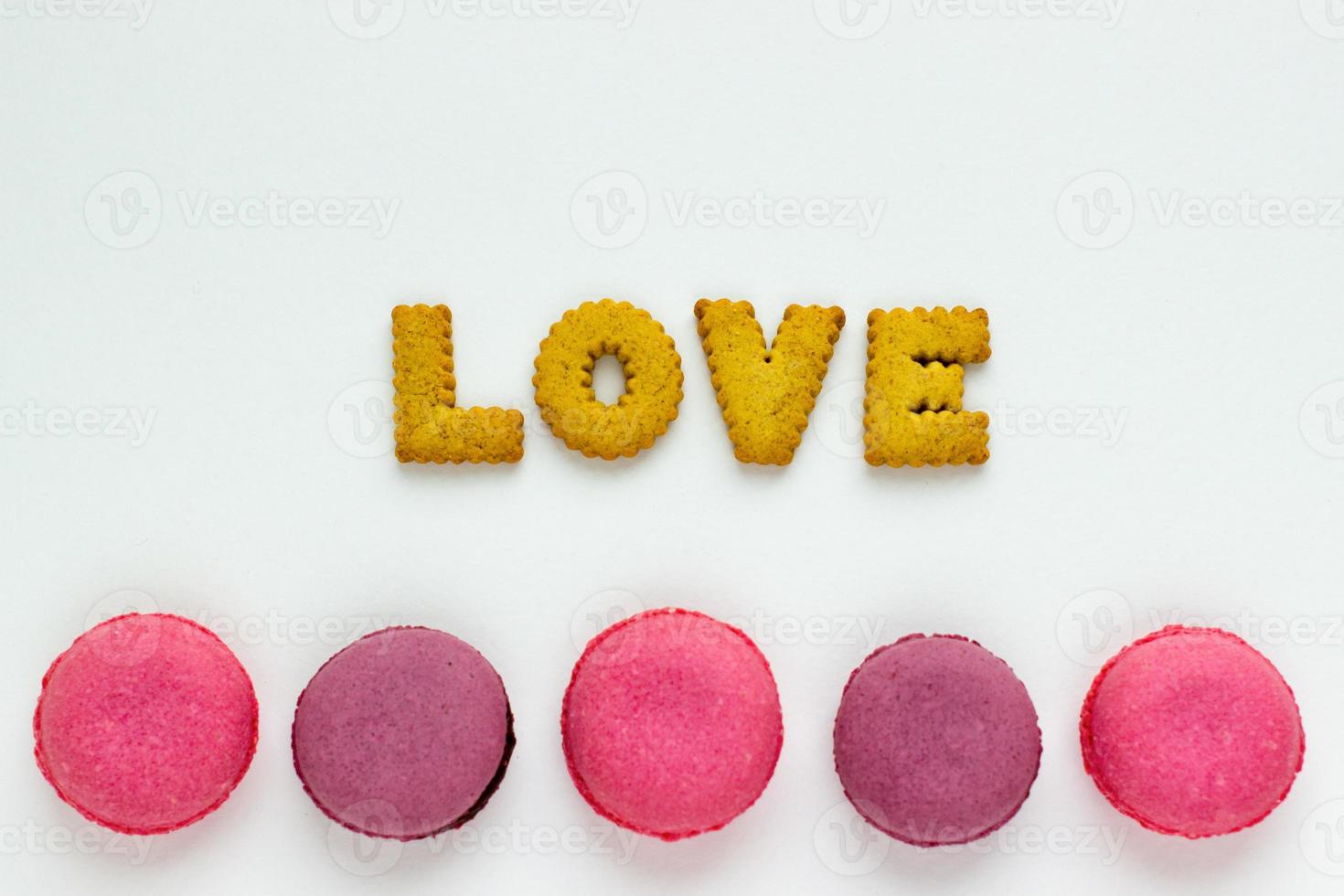 Sweet food minimalist background with cookies and pink macaroons. photo