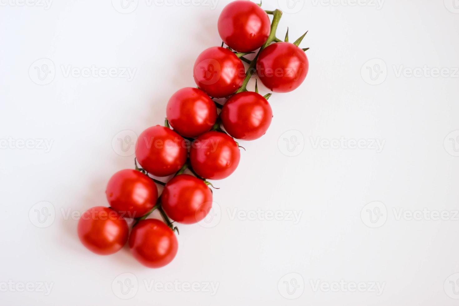 Fresh red delicious cherry tomatoes on white background. Summer agriculture. Italian cousine.Shallow DOF, selective focus image. photo