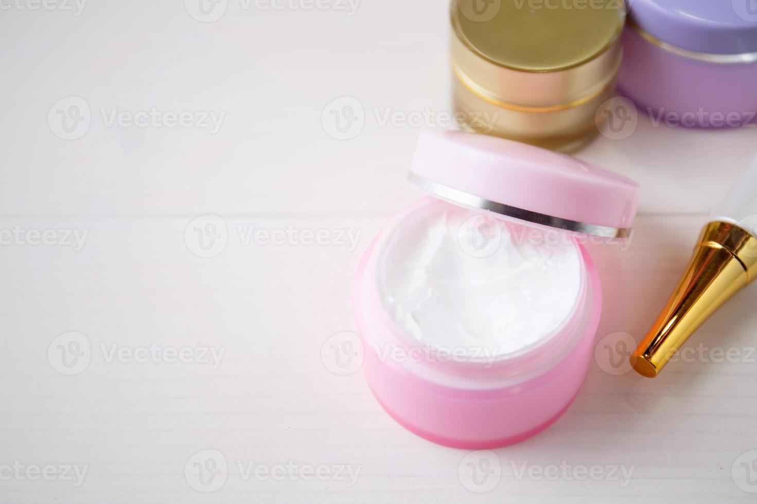 cosmetic and skin care product on white wood table, beauty with treatment cream and moisturizing on wooden desk, health and wellness concept. photo